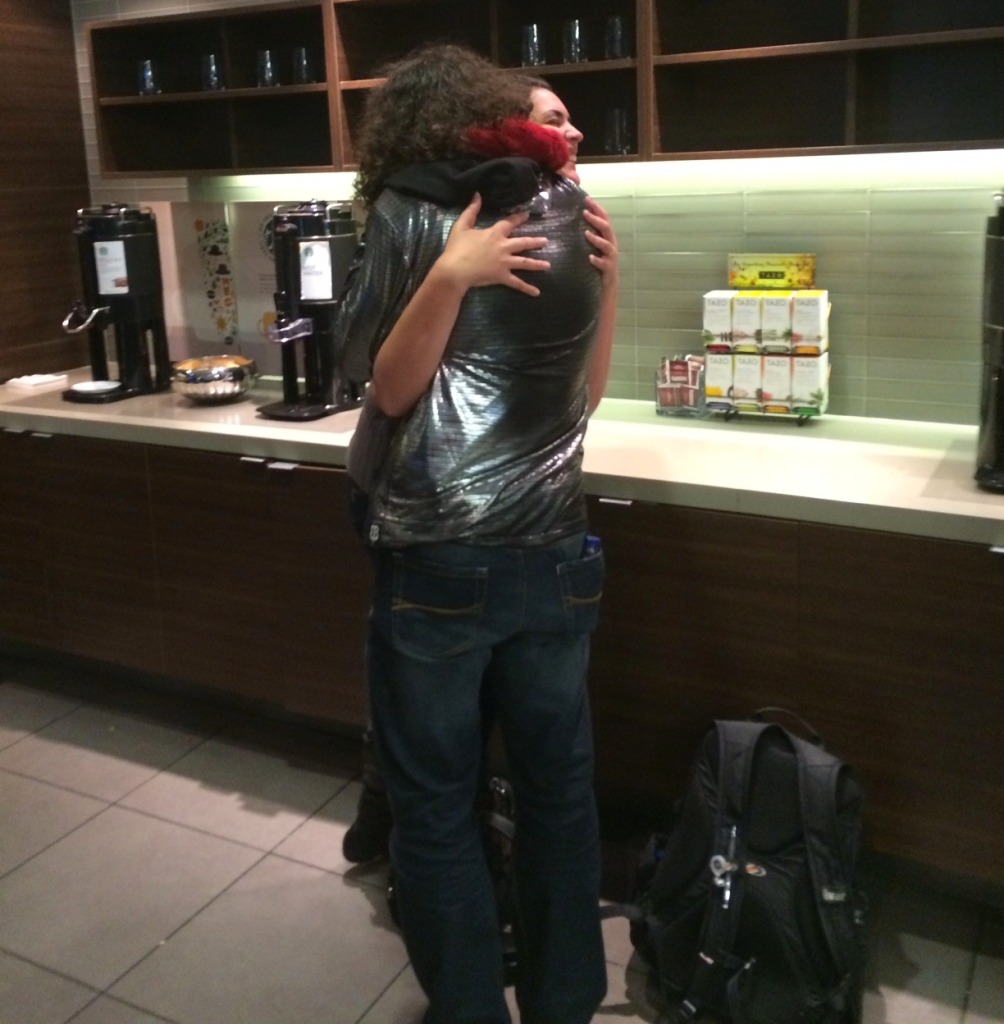 Malcolm hugging a stranger.