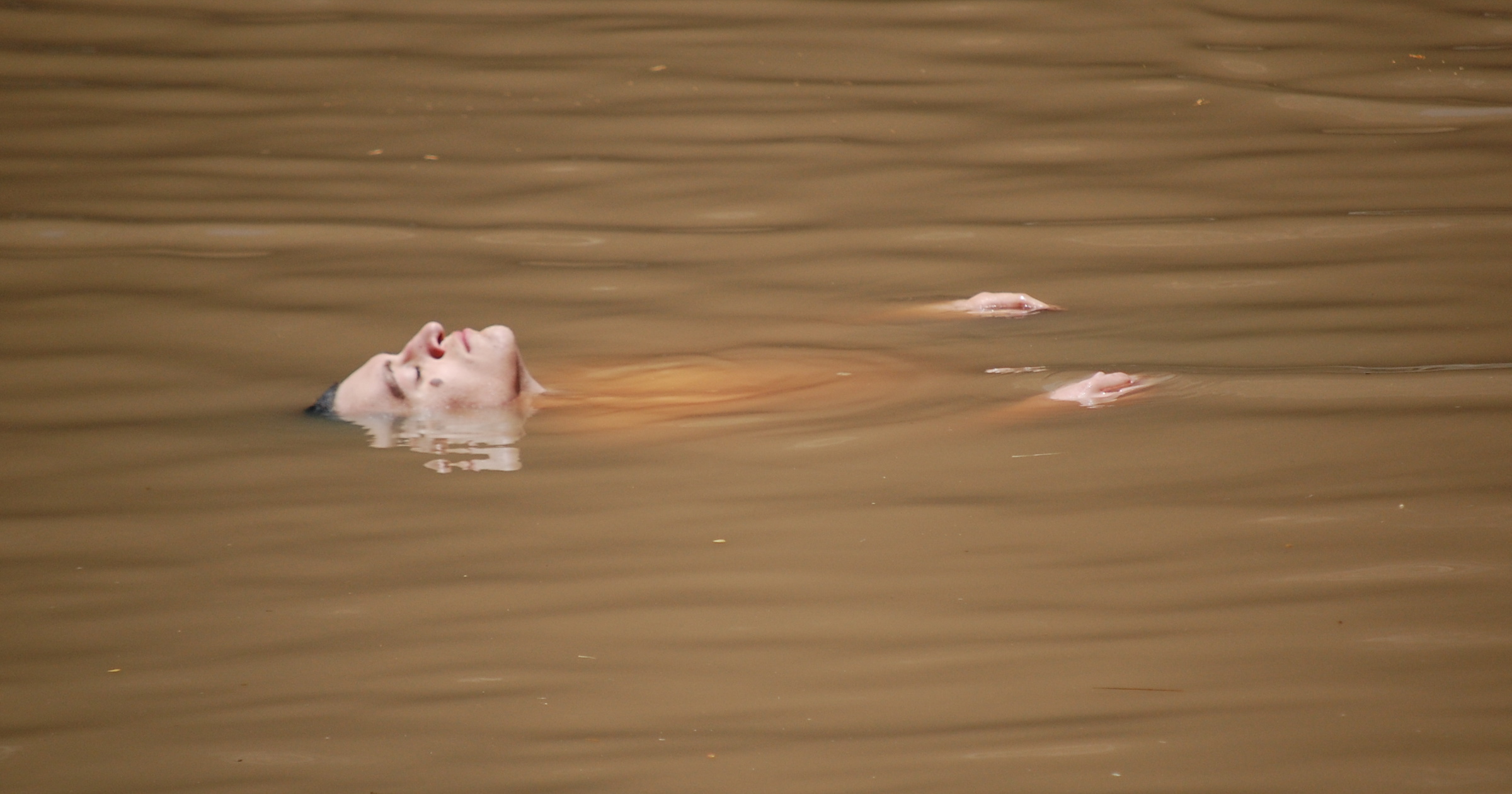 an photo of me floating in muddy water, on the day of this story
